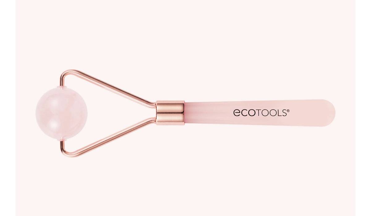 A rose quartz facial roller with a spherical stone on one end and a handle, branded with the Ecotools logo, against a soft background.