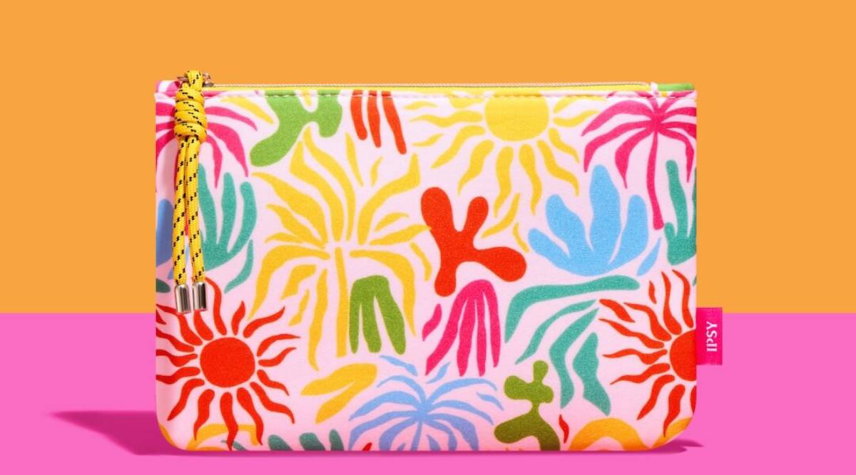 Colorful makeup pouch featuring bright sun and plant motifs, set against an orange and pink backdrop.
