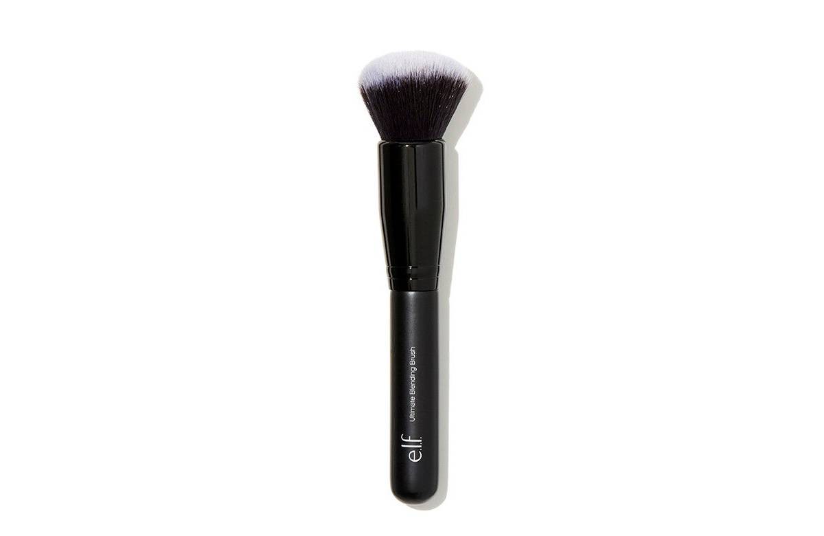 Black handle makeup brush with a tapered, fluffy head designed for blending foundation and other products seamlessly.