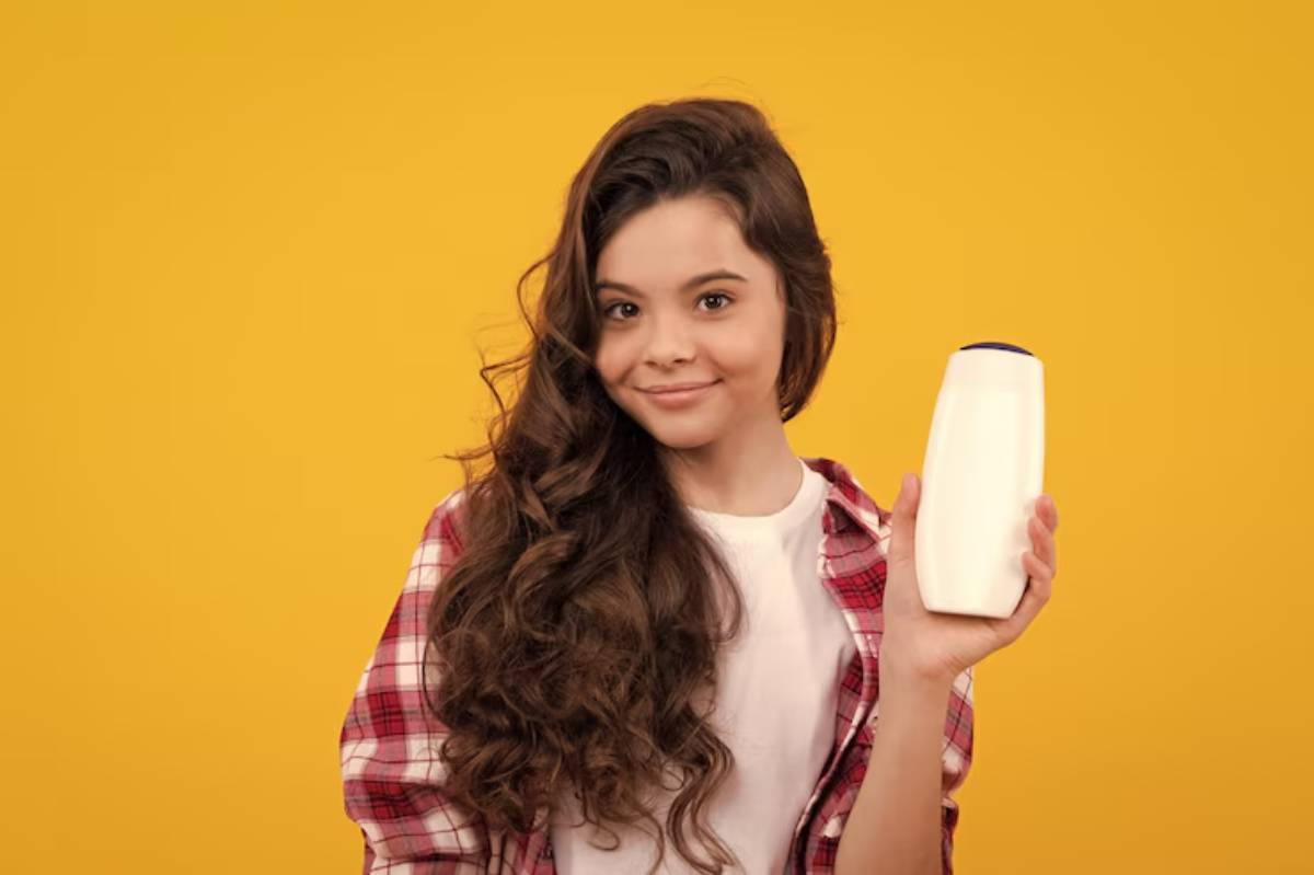 A person in a plaid shirt holds a white bottle against a bright yellow background, showcasing hair care or beauty product.